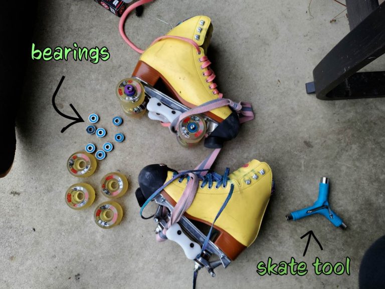an image of yellow skates. one of the boots has had its wheels and bearings removed are are pictured to the left. a skate blue, tri skate tool is to the right of the boots