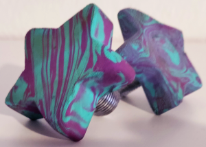 two purple and blue swirled, star shaped toestops for roller skates