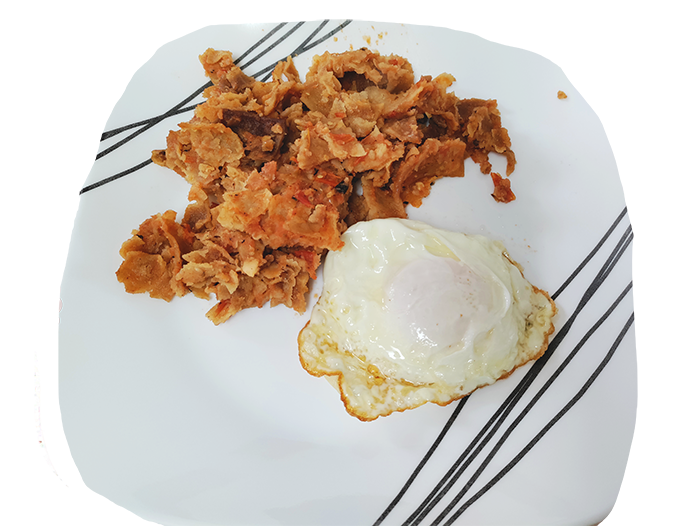 red sauce chilaquiles next to an overmedium egg