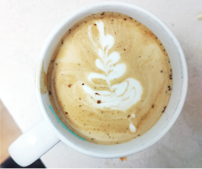 white leaf latte art in a ceramic mug