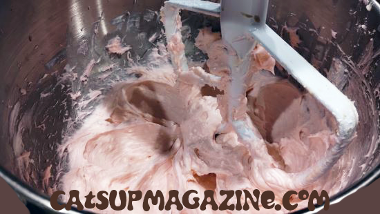 pink cream cheese frosting in a stand mixer