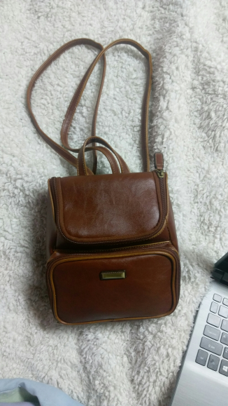 A small brown imitation leather brandless backpack.